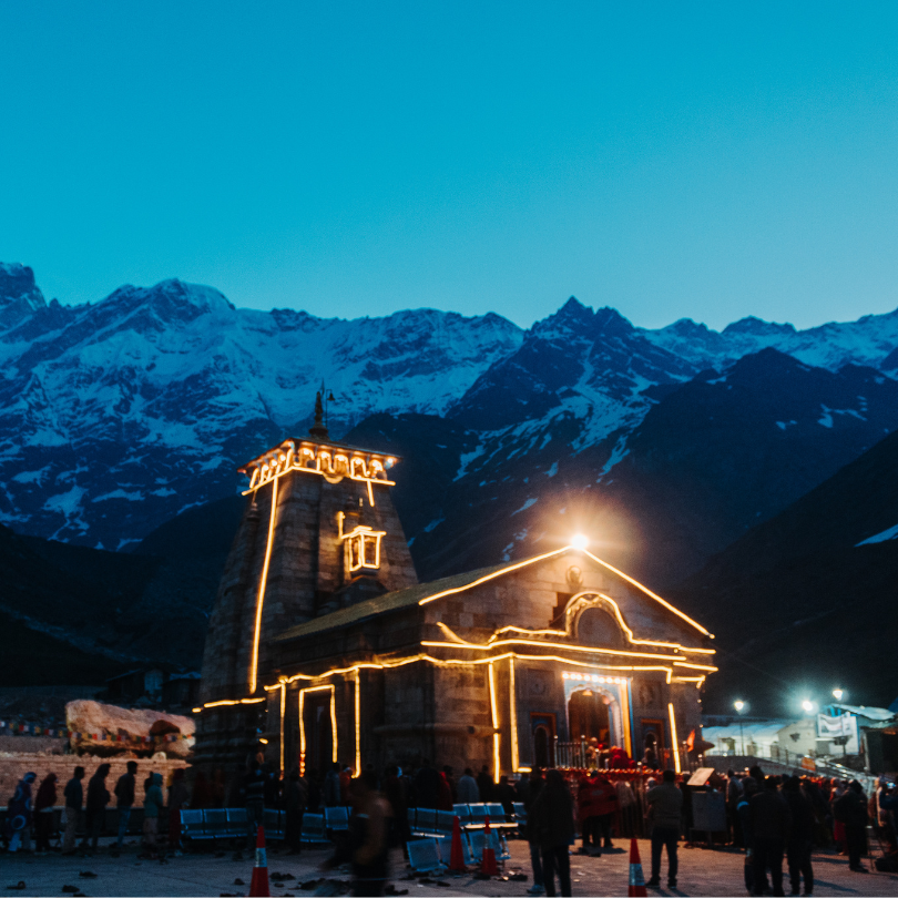 a crowd standing in front of the kedarnath temple in kedarnath india during a ceremony