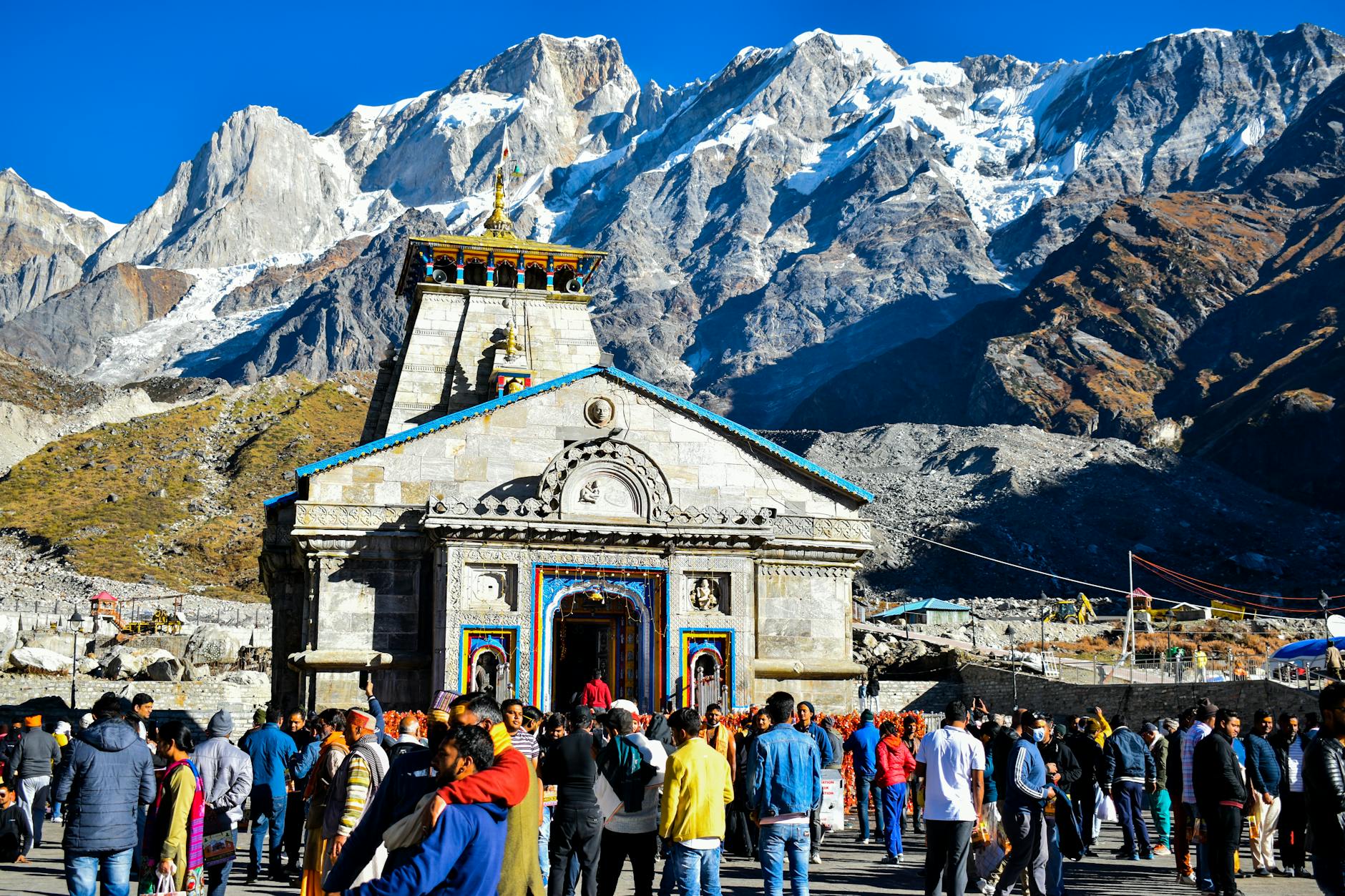 a crowd standing in front of the kedarnath temple in kedarnath india during a ceremony